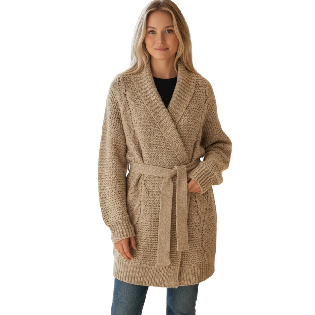Beige chunky knit oversized wrap cardigan with cable knit details and a matching belt tie, worn by a woman with blue jeans.