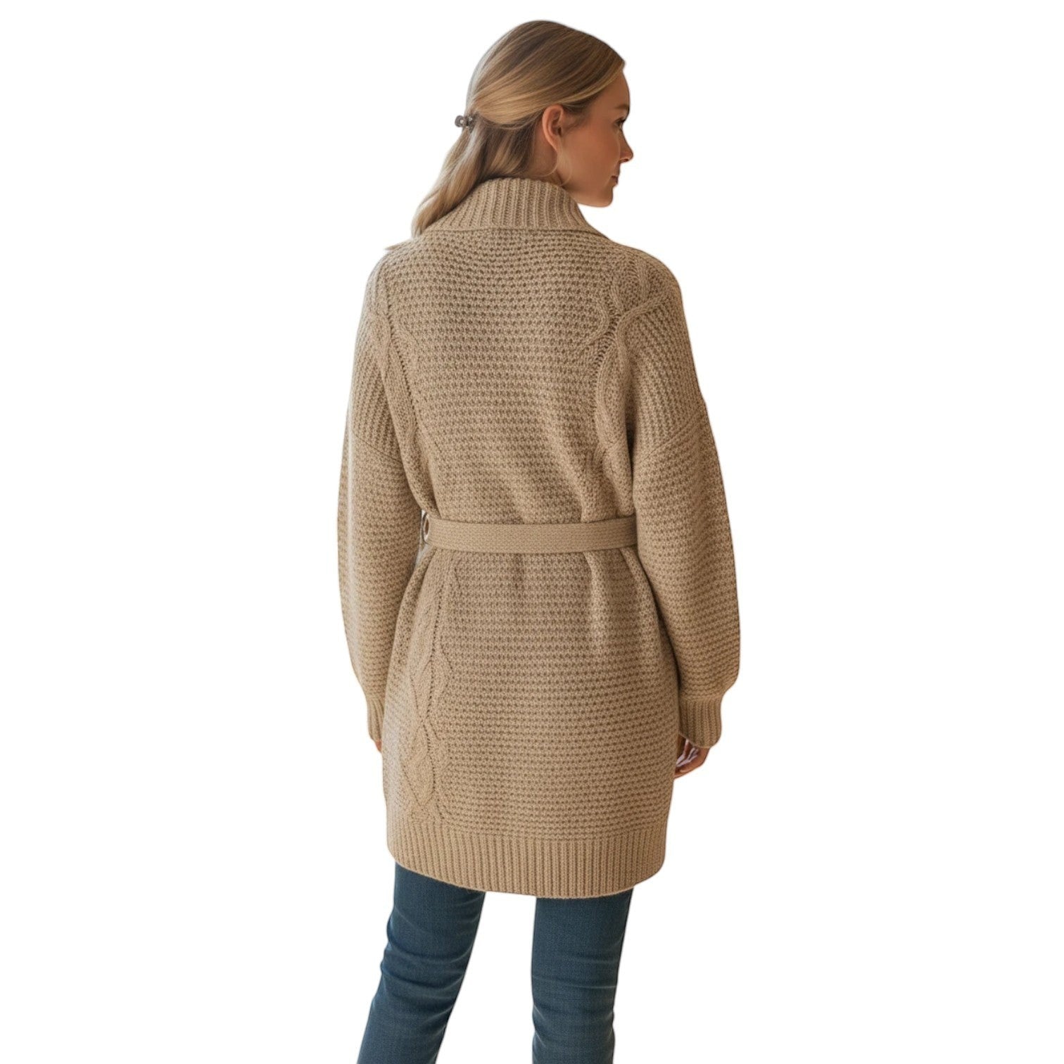 Woman wearing a beige chunky knit oversized wrap cardigan with a belt tie, featuring cable knit detailing on the back.