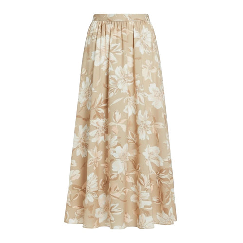 Flowing beige maxi skirt with an all-over white and tan floral print and an elastic waistband.