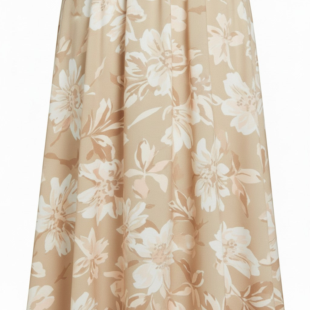 Flowing A-line midi skirt in beige with a large floral print in white and tan. Features an elastic waistband and a lightweight, soft fabric.