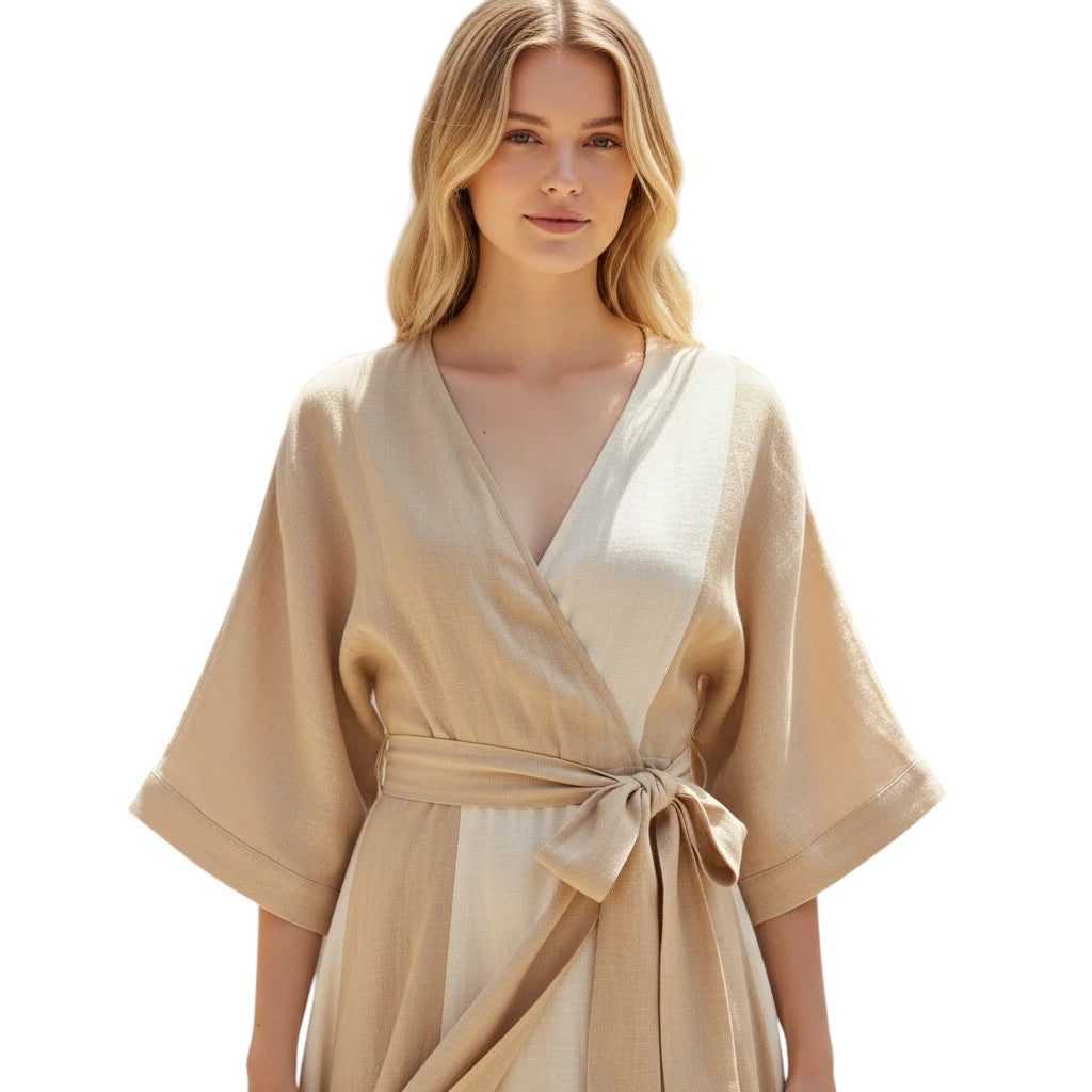 Woman wearing a neutral striped linen wrap midi dress with a V-neckline and self-tie belt.