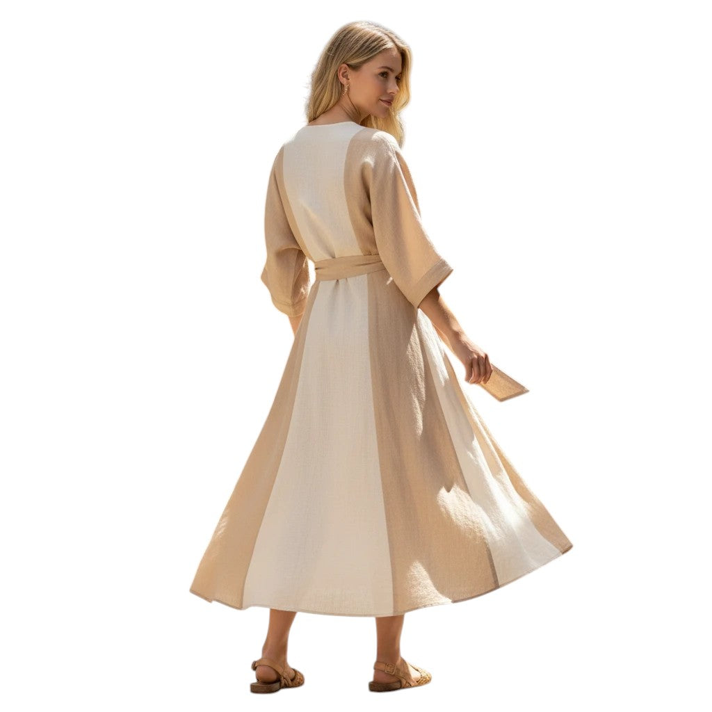 Woman wearing a beige and cream striped linen wrap midi dress with a V-neck and self-tie belt, styled with flat sandals.