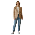 White & Rustic Boutique camel textured single button blazer with lapel and flap pockets, worn by a woman with jeans.