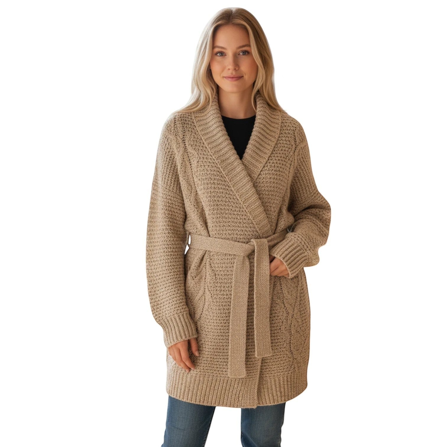Woman wearing a beige cable knit belted cardigan sweater with a shawl collar, paired with blue jeans.